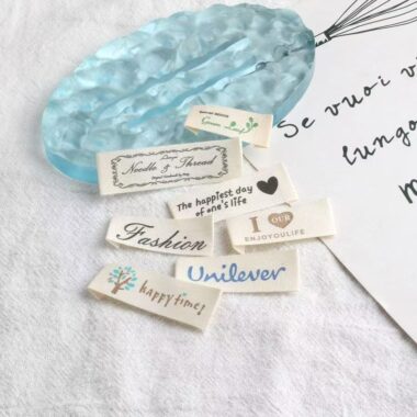 Beige embroidered alphabet clothing label for garments and bags