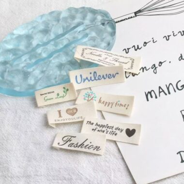 Beige embroidered alphabet clothing label for garments and bags