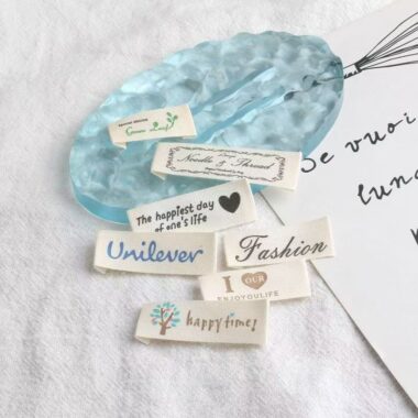 Beige embroidered alphabet clothing label for garments and bags