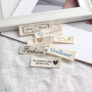 Beige embroidered alphabet clothing label for garments and bags