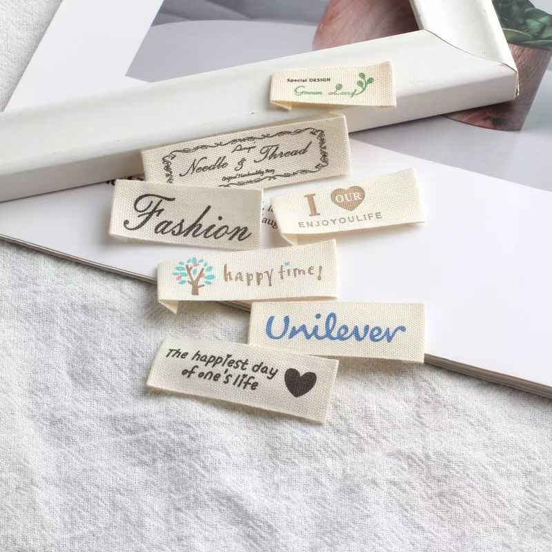 Beige embroidered alphabet clothing label for garments and bags