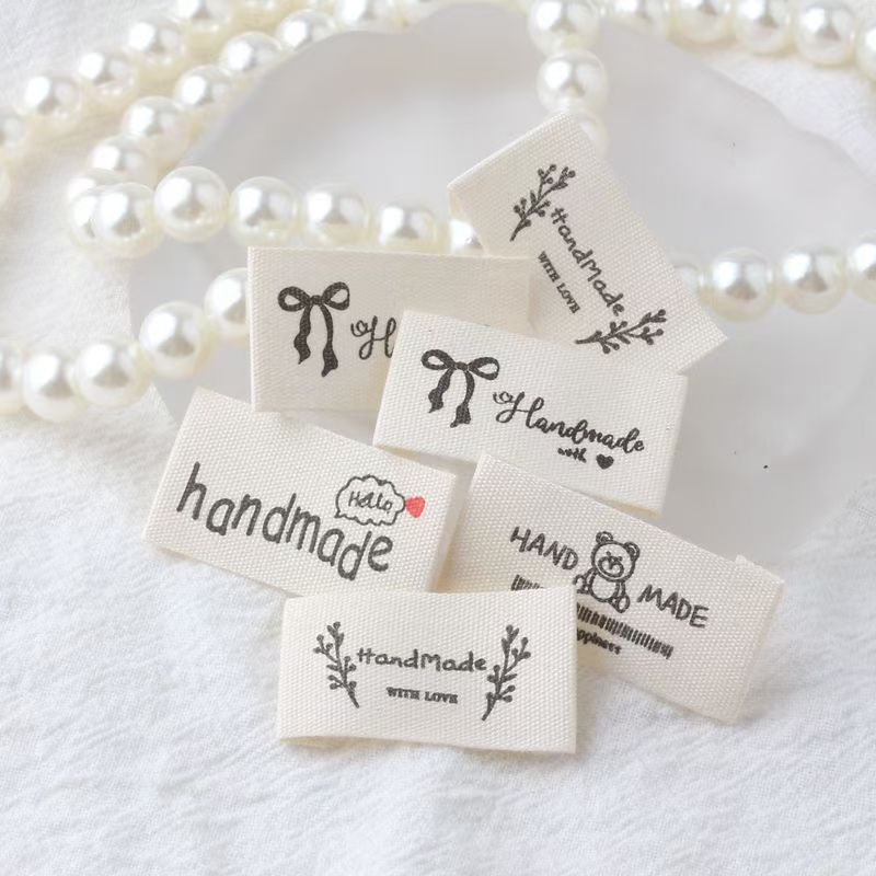 Beige embroidered alphabet woven label for clothing and handmade accessories