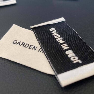 Custom designed sew-in folded woven clothing labels